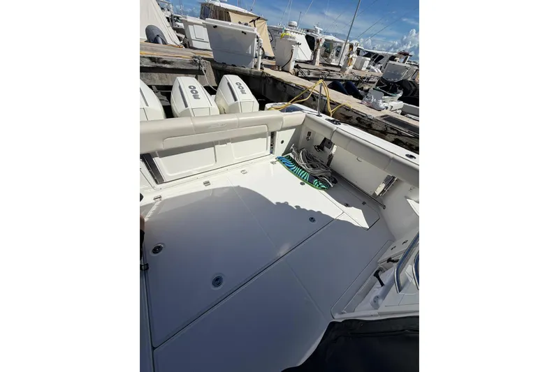  Yacht Photos Pics 2023 Boston Whaler 345 Conquest boat deck with twin engines at dock.