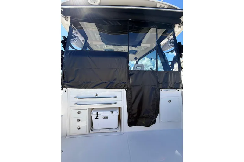  Yacht Photos Pics 2023 Boston Whaler 345 Conquest boat with black cover and Yeti cooler.