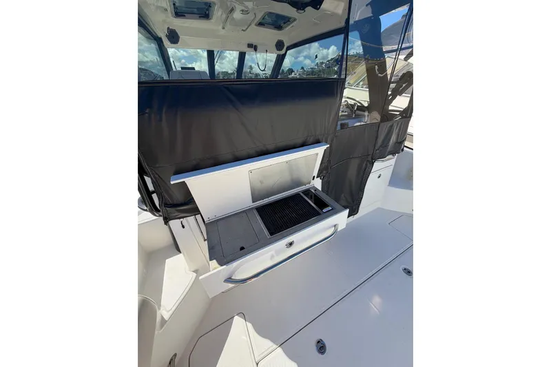  Yacht Photos Pics 2023 Boston Whaler 345 Conquest boat with outdoor grill and seating area.