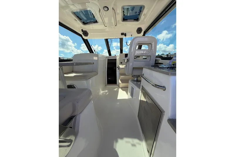  Yacht Photos Pics Interior of 2023 Boston Whaler 345 Conquest boat, featuring modern seating and helm.