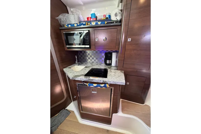  Yacht Photos Pics 2023 Boston Whaler 345 Conquest galley with microwave, sink, and cooktop.