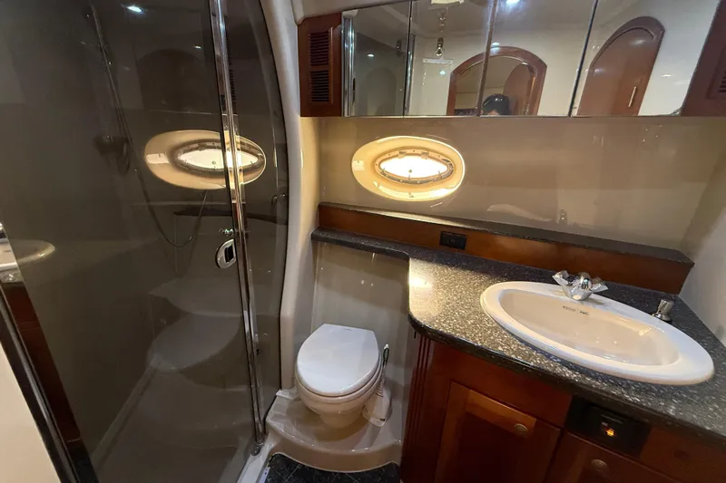  Yacht Photos Pics Luxurious bathroom in 2007 Cruisers Yachts 560 Express with modern fixtures and elegant design.