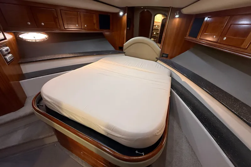  Yacht Photos Pics Luxurious cabin interior of 2007 Cruisers Yachts 560 Express with elegant wood finishes.