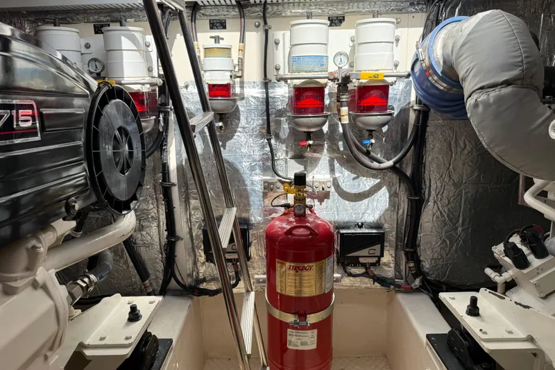  Yacht Photos Pics Engine room of 2007 Cruisers Yachts 560 Express, featuring filters and fire extinguisher.