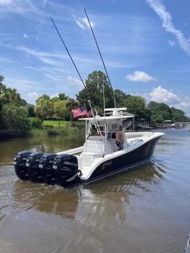  Yacht Photos Pics 2007 Yellowfin 36 boat with triple outboard motors cruising on a scenic river.
