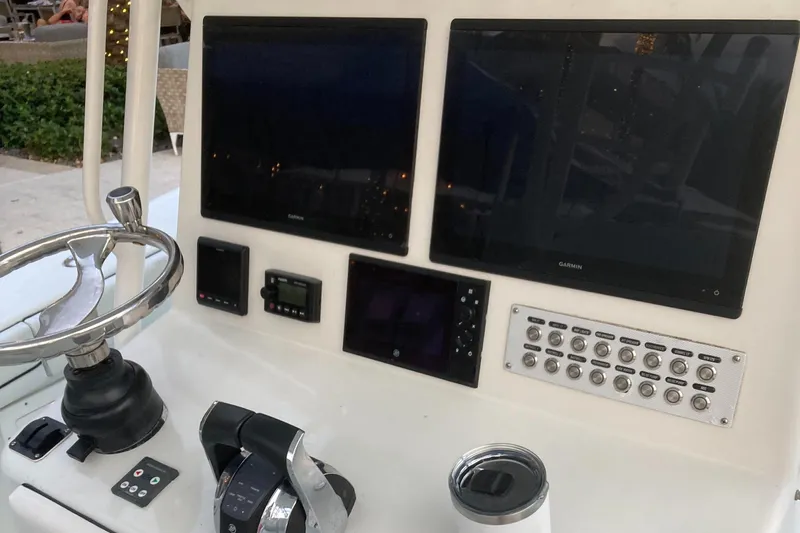  Yacht Photos Pics Control panel of a 2007 Yellowfin 36 boat with dual screens and steering wheel.