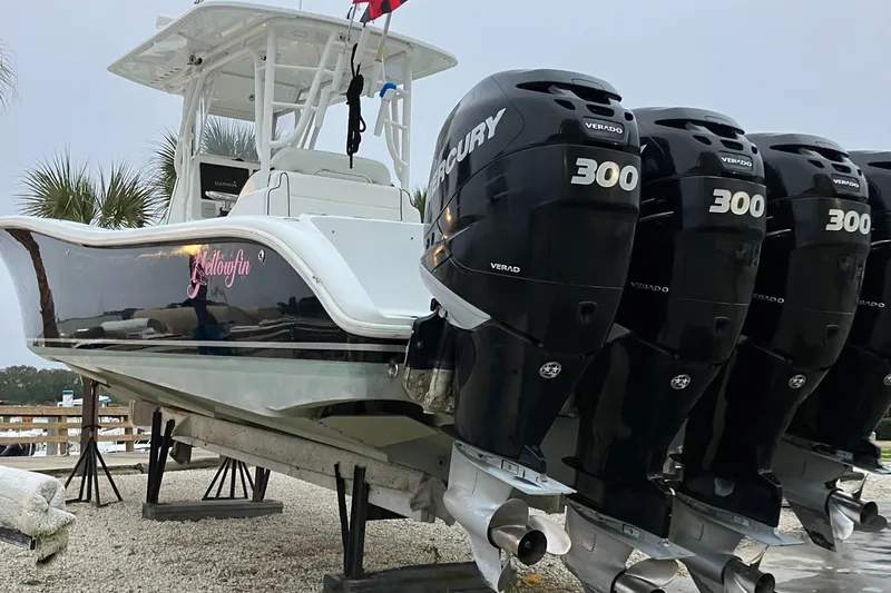  Yacht Photos Pics 2007 Yellowfin 36 boat with four Mercury 300 engines, docked on a gravel surface.