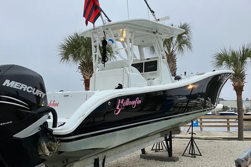  Yacht Photos Pics 2007 Yellowfin 36 boat with Mercury engine, docked near palm trees.