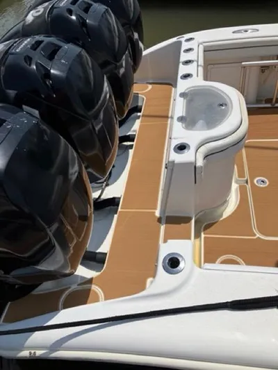  Yacht Photos Pics 2007 Yellowfin 36 boat deck with multiple outboard engines and seating area.