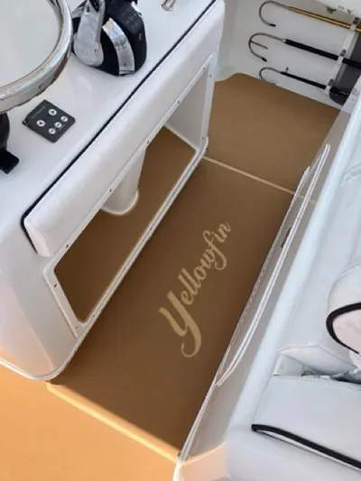  Yacht Photos Pics 2007 Yellowfin 36 boat interior with branded flooring and fishing rod holders.