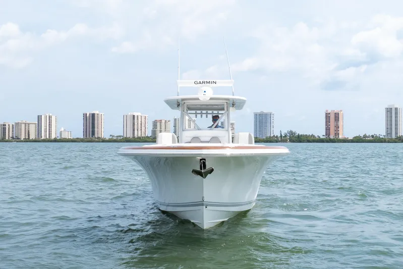  Yacht Photos Pics 2026 Buddy Davis 34 Center Console boat on water with city skyline background.
