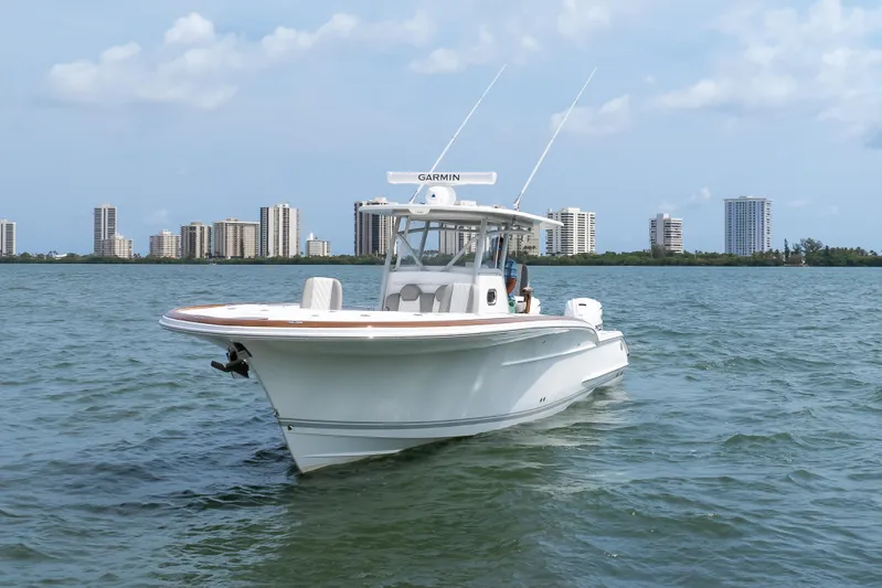  Yacht Photos Pics 2026 Buddy Davis 34 Center Console boat on water with city skyline background.