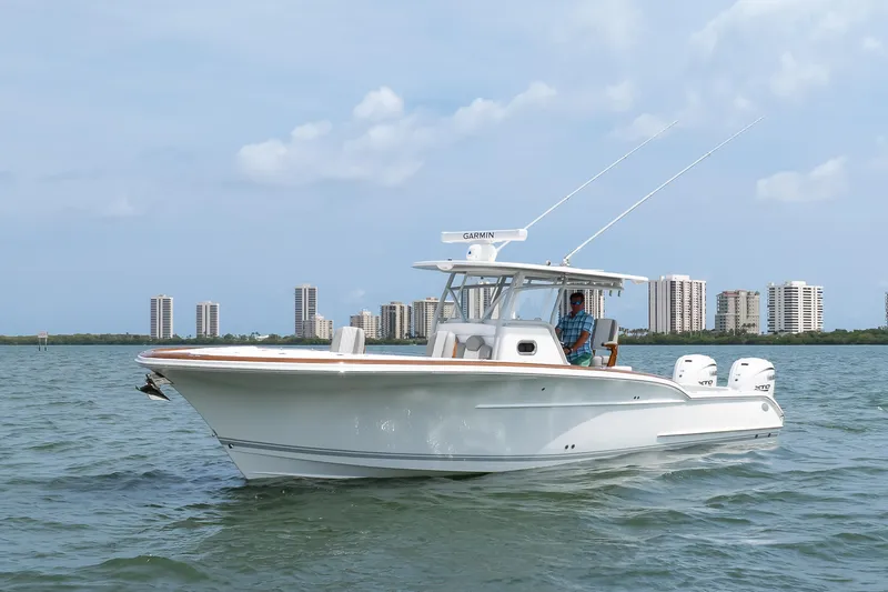  Yacht Photos Pics 2026 Buddy Davis 34 Center Console boat on water with city skyline background.