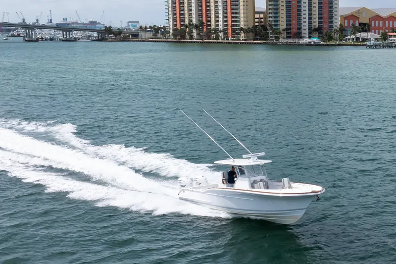  Yacht Photos Pics 2026 Buddy Davis 34 Center Console cruising on water near city skyline.