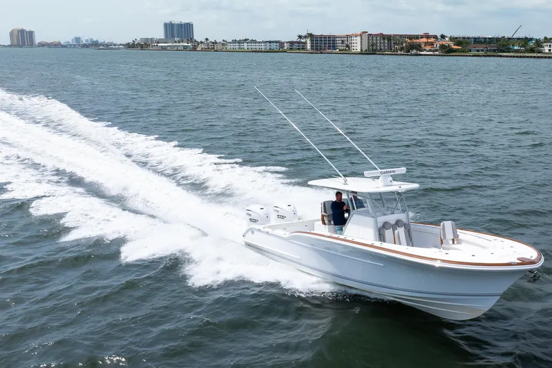  Yacht Photos Pics 2026 Buddy Davis 34 Center Console cruising on open water, showcasing sleek design and performance.