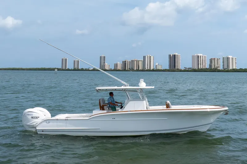  Yacht Photos Pics 2026 Buddy Davis 34 Center Console boat on water with city skyline background.