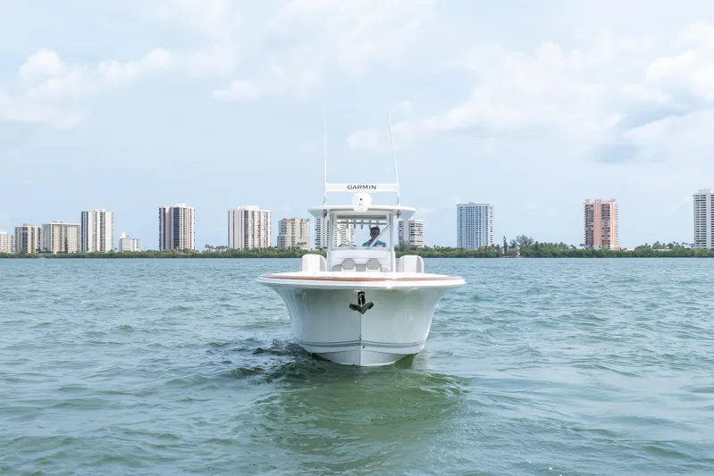  Yacht Photos Pics 2026 Buddy Davis 34 Center Console boat on water with city skyline background.