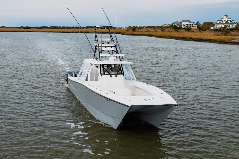  Yacht Photos Pics 2018 Freeman 37 VH boat cruising on a calm river with scenic background.