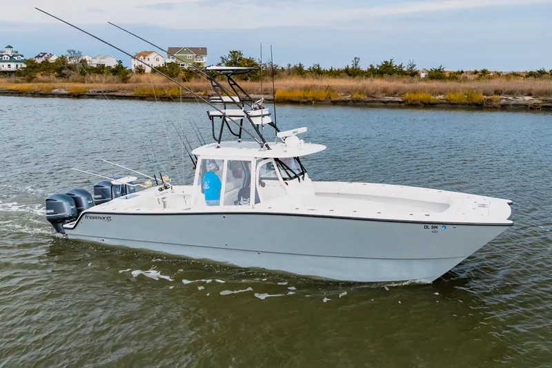  Yacht Photos Pics 2018 Freeman 37 VH boat cruising on a calm river with fishing rods.