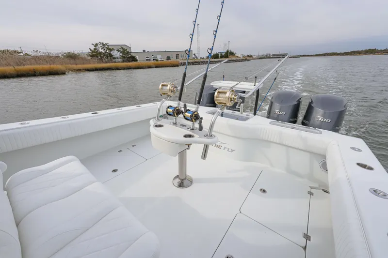  Yacht Photos Pics 2018 Freeman 37 VH fishing boat with rods and triple 300 engines on a calm waterway.