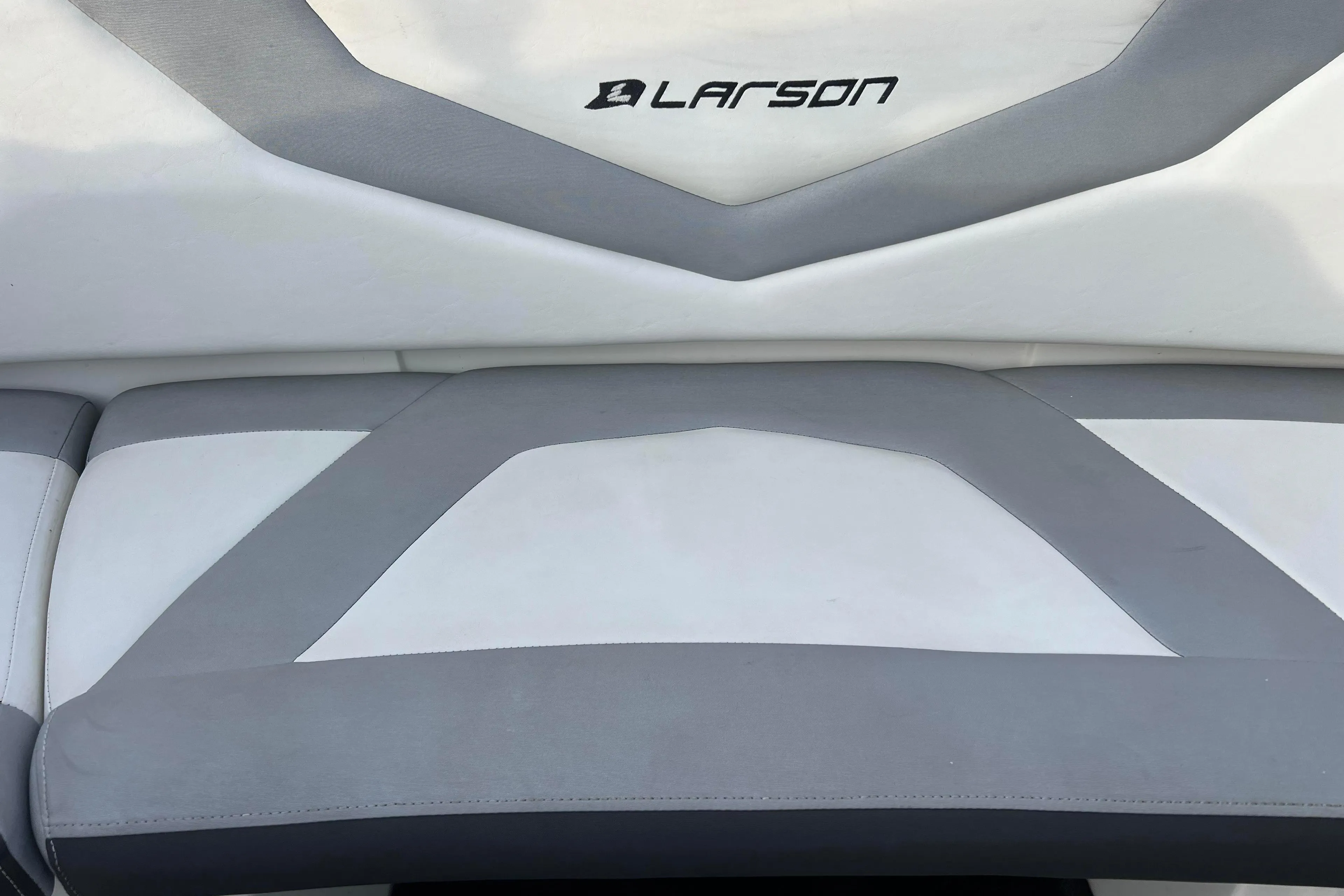 2013 Larson LX 205S IO boat seat with gray and white upholstery.