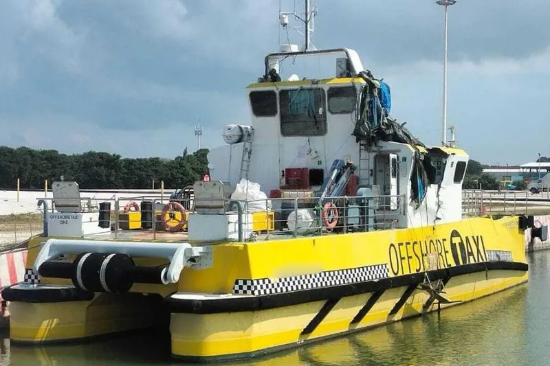  Yacht Photos Pics Yellow Offshore Fast Crew Taxi Catamaran by Mützelfeldtwerft, 2016, docked at a port.