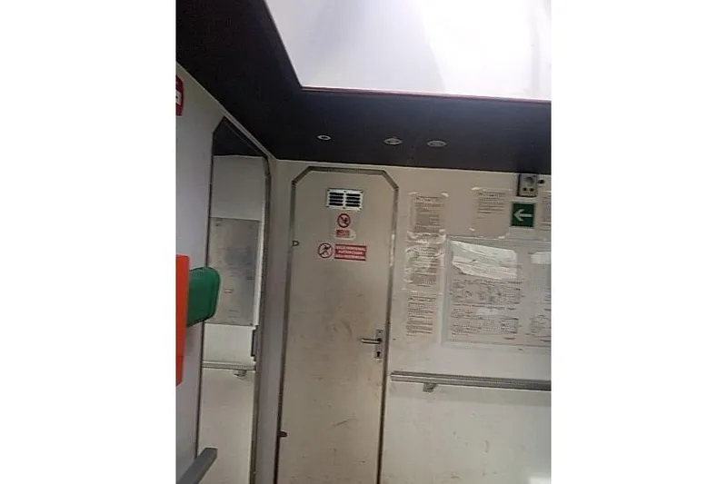  Yacht Photos Pics Interior of a 2016 Mützelfeldtwerft Offshore Fast Crew Taxi Catamaran, featuring a door and safety signs.