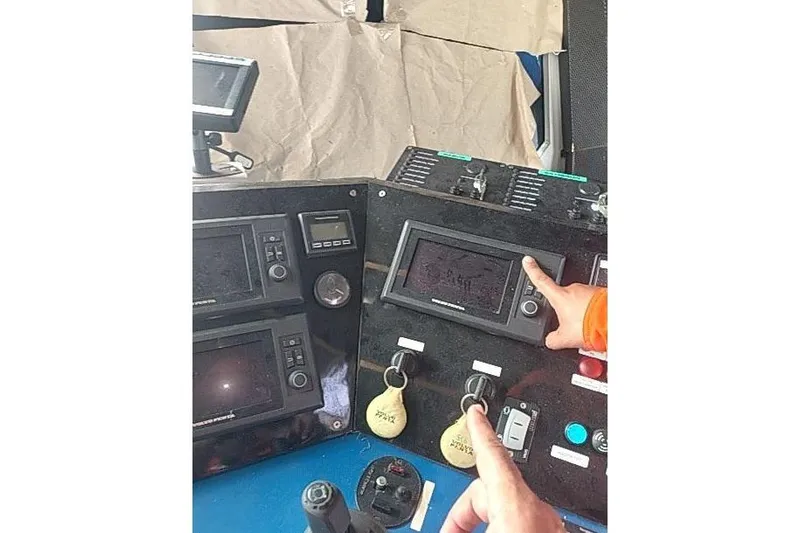  Yacht Photos Pics Control panel of a 2016 Mützelfeldtwerft Offshore Fast Crew Taxi Catamaran with navigation screens.