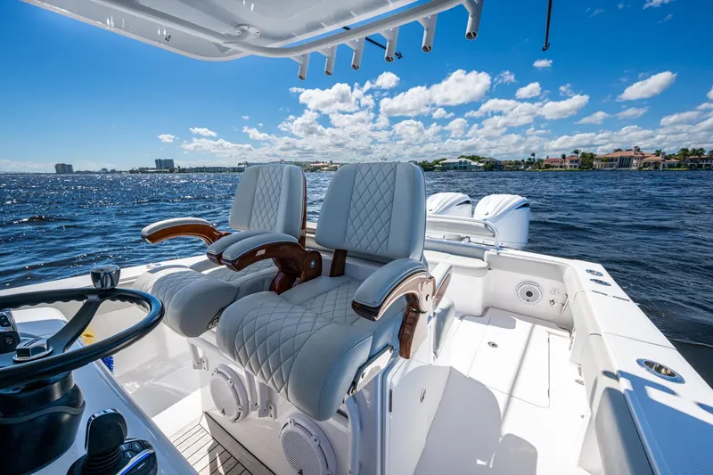  Yacht Photos Pics Luxurious 2022 Jupiter 32 boat interior with plush seating on a sunny day.