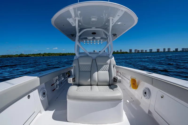  Yacht Photos Pics 2022 Jupiter 32 boat interior with cushioned seating on open water.