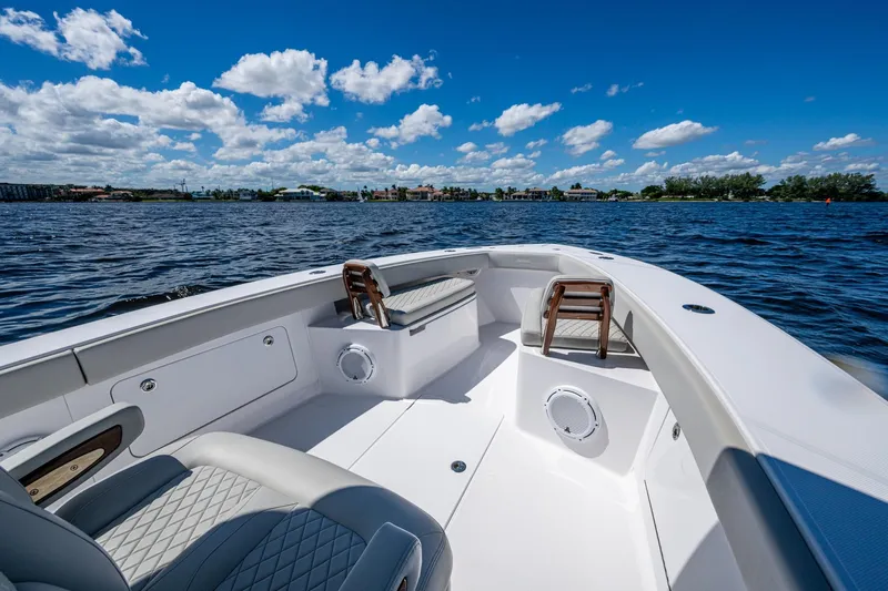  Yacht Photos Pics 2022 Jupiter 32 boat interior with seating, on a sunny day, overlooking calm waters.