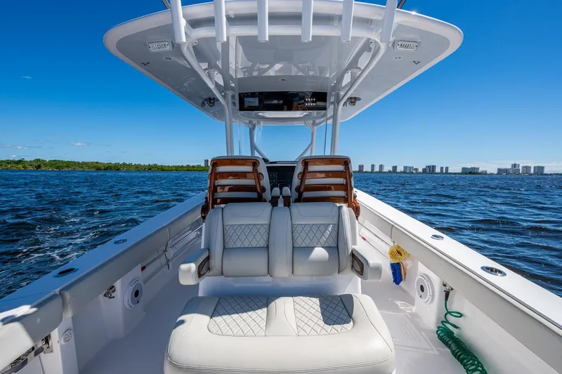  Yacht Photos Pics 2022 Jupiter 32 boat interior on open water, featuring luxurious seating and clear blue skies.