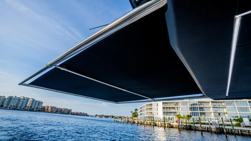  Yacht Photos Pics 2024 Rio Yachts Daytona 50 with extended awning over scenic waterfront.