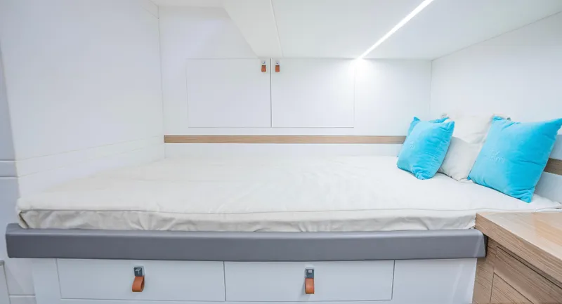  Yacht Photos Pics 2024 Rio Yachts Daytona 50 cabin with modern bedding and blue accent pillows.