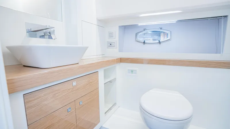  Yacht Photos Pics Luxurious bathroom in 2024 Rio Yachts Daytona 50, featuring modern fixtures and elegant design.