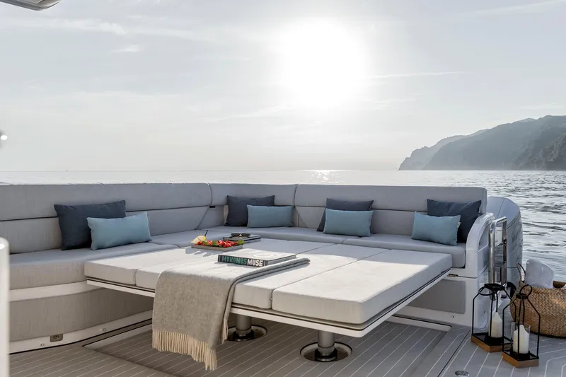  Yacht Photos Pics Luxurious 2025 Azimut Verve 48 yacht deck with elegant seating, ocean view, and sunset ambiance.