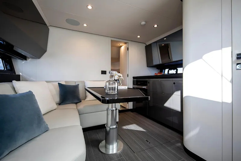  Yacht Photos Pics Luxurious interior of 2025 Azimut Verve 48 yacht with modern seating and sleek kitchen design.