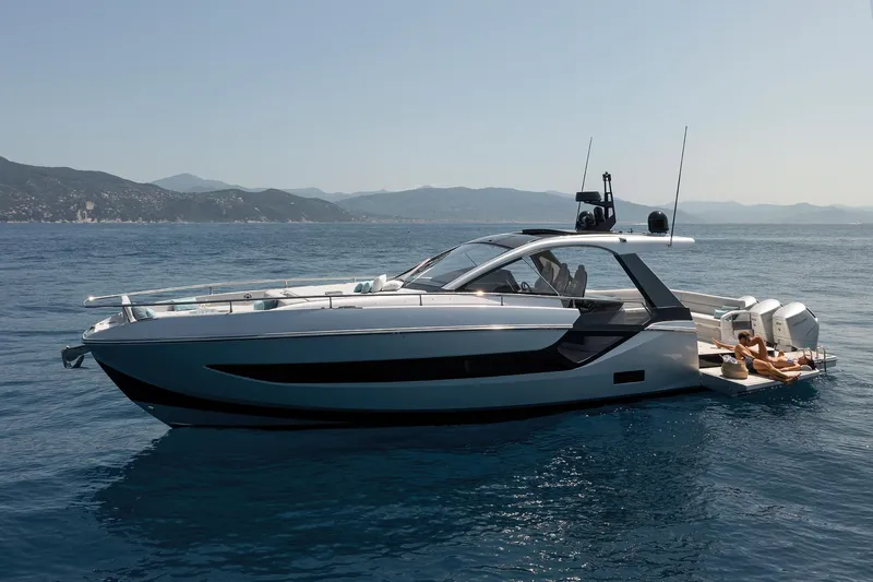 Yacht Photos Pics 2025 Azimut Verve 48 yacht cruising on serene waters with scenic mountain backdrop.