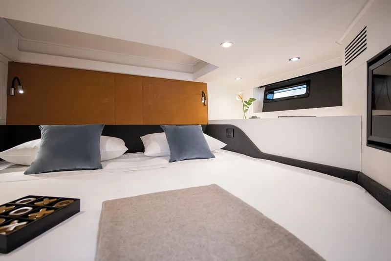  Yacht Photos Pics Luxurious bedroom interior of 2025 Azimut Verve 48 yacht with modern design and cozy bedding.