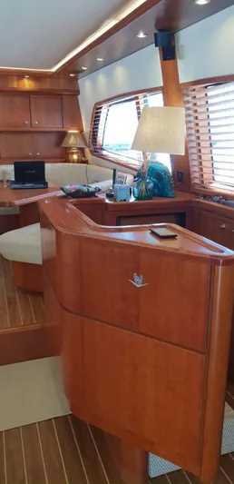 Bouki Yacht Photos Pics Interior of 2006 Bertram 670 yacht with wooden furnishings and modern decor.
