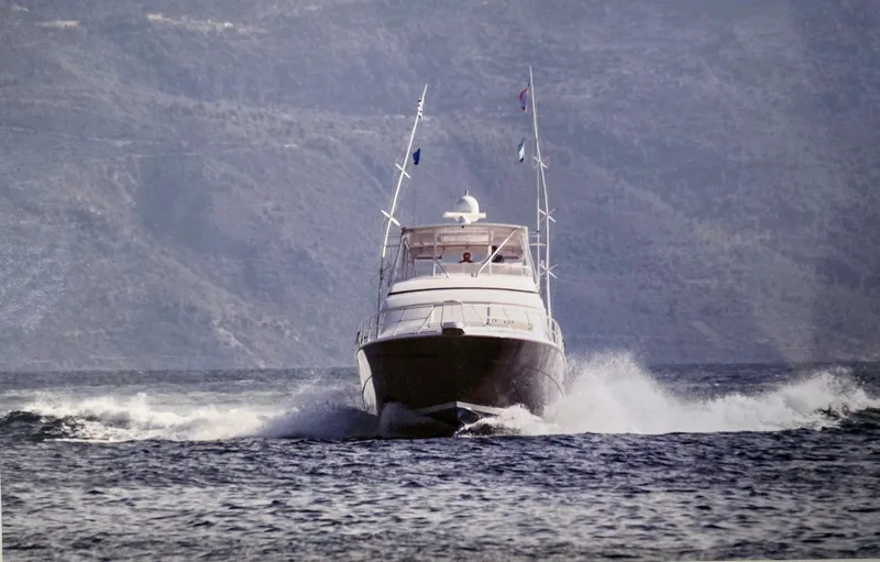 Bouki Yacht Photos Pics Bertram 670 yacht cruising on open water, 2006 model.