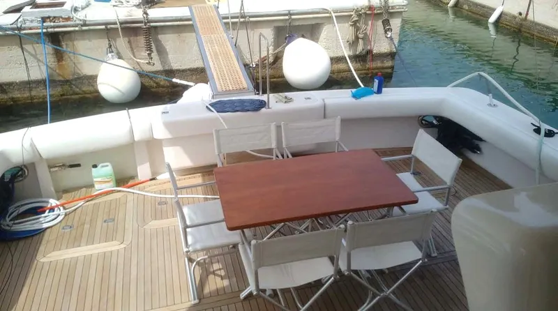 Bouki Yacht Photos Pics Bertram 670 yacht deck with table and chairs, 2006 model.