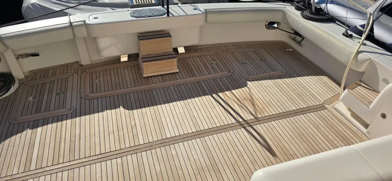 Bouki Yacht Photos Pics Spacious deck of a 2006 Bertram 670 yacht with wooden flooring.