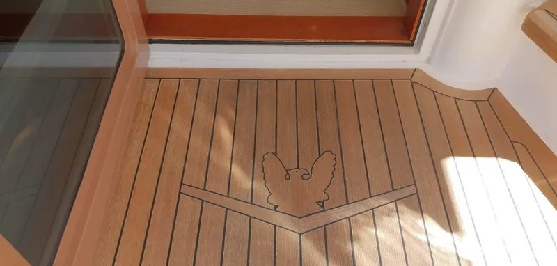 Bouki Yacht Photos Pics Teak deck with eagle design on a 2006 Bertram 670 yacht.