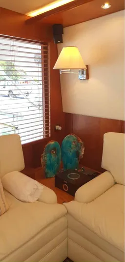 Bouki Yacht Photos Pics Interior of 2006 Bertram 670 yacht with beige seating and decorative accents.