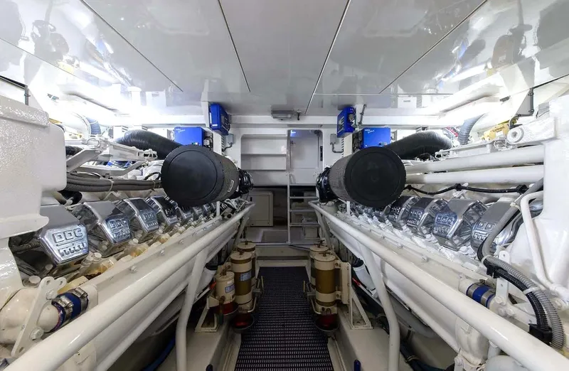 Bouki Yacht Photos Pics Engine room of a 2006 Bertram 670 yacht, featuring dual engines and clean, organized layout.