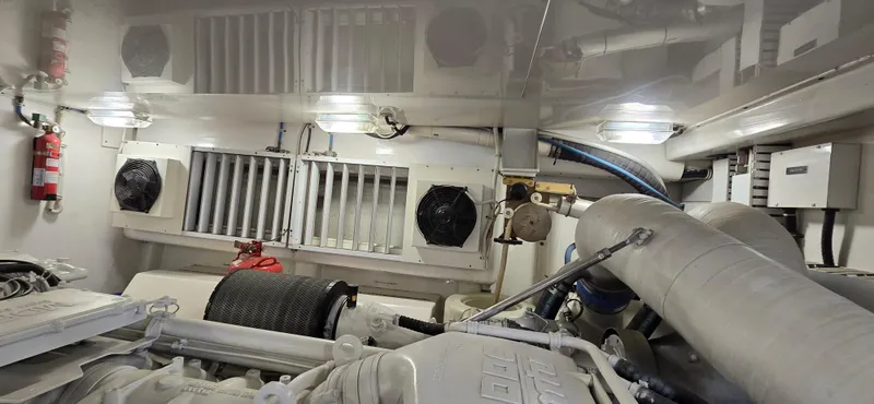Bouki Yacht Photos Pics Engine room of 2006 Bertram 670 yacht, featuring mechanical components and ventilation system.