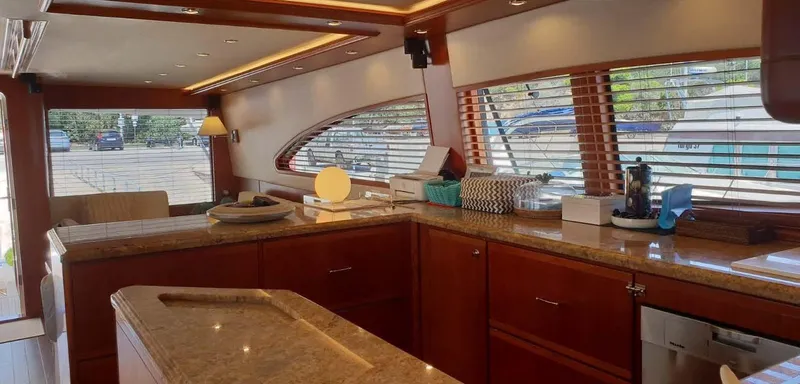 Bouki Yacht Photos Pics Luxurious interior of a 2006 Bertram 670 yacht with elegant wood and granite finishes.