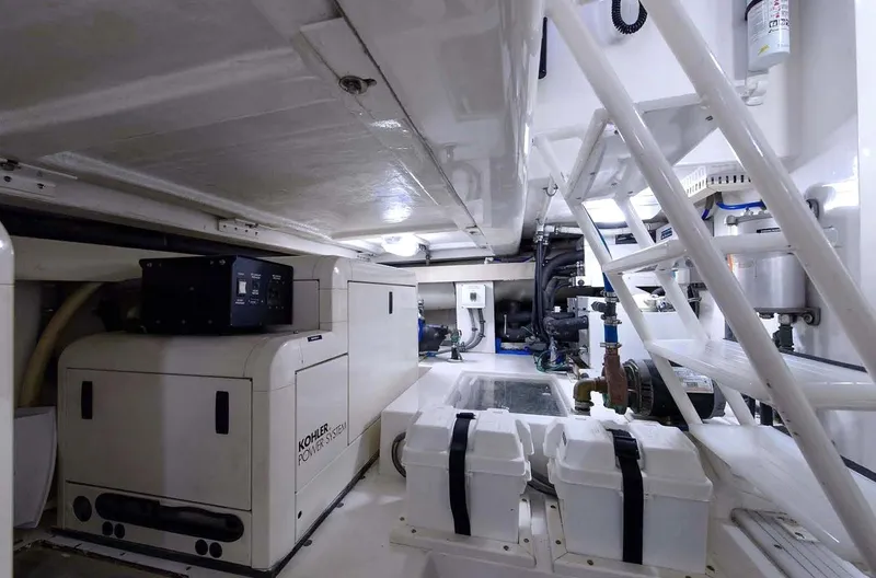 Bouki Yacht Photos Pics Engine room of 2006 Bertram 670 yacht, featuring equipment and storage.