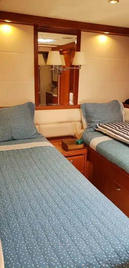 Bouki Yacht Photos Pics Cozy twin cabin in 2006 Bertram 670 yacht with blue bedding.